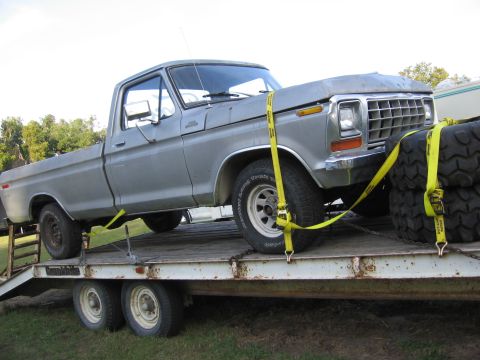 1979 Ford F-150 - Silver 1979 Ford F-150 pickup truck being transported on a flatbed trailer.