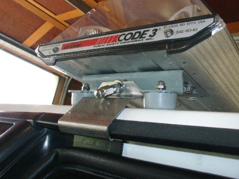 1993 Ford Mustang - Close-up of a Code 3 light bar mount, showing model number SAE-W3-83.