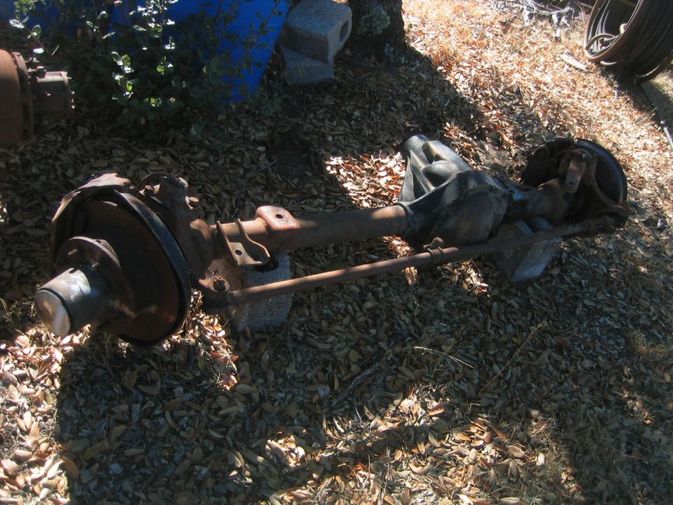 Dana 60 axle assembly with disc brakes, resting on blocks outdoors