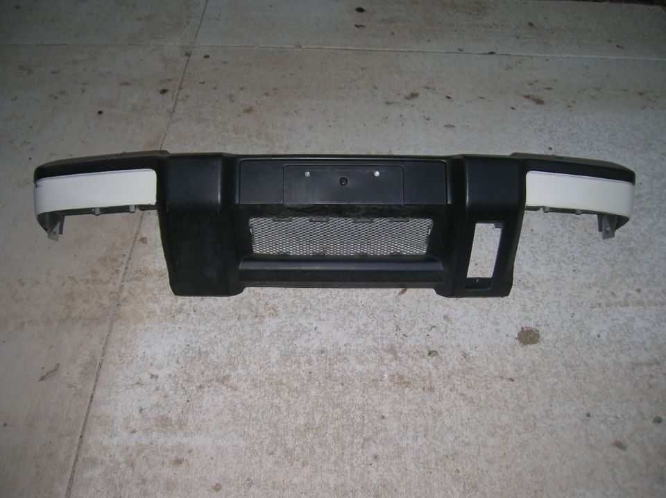 black and white front bumper with mesh grille and license plate mount