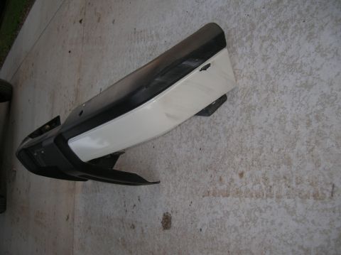1999 Land Rover Discovery II - A detached car bumper is shown resting on a concrete surface.