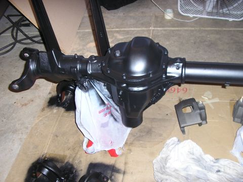 1996 Ford Bronco - A black differential axle assembly is shown, with a plastic bag and other parts nearby.