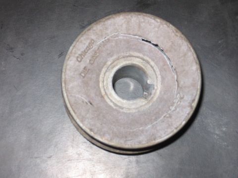 2001 Ford F-150 - A pulley with visible text indicating it is from Chicago Die Cast is shown against a metallic surface.