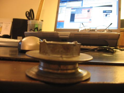 2001 Ford F-150 - A metal component sits on a desk, with a laptop and office supplies in the background.