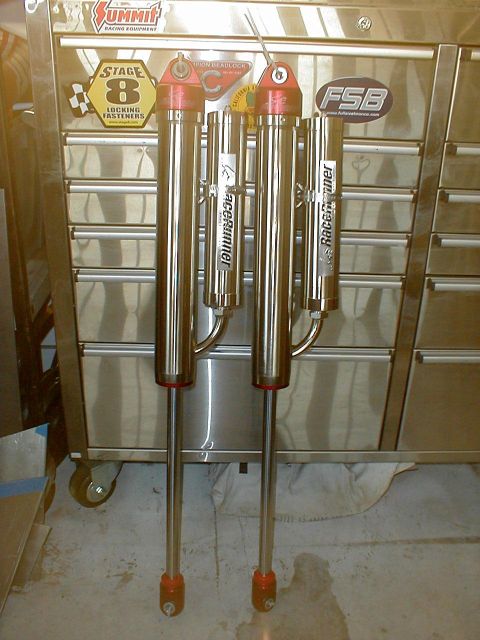 1996 Ford Bronco - Two RaceRunner shock absorbers are displayed against a metal tool chest.