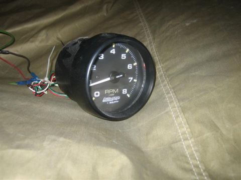 1900 Yugo Vega - This Auto Gage tachometer displays RPM readings and has several wires connected for installation.