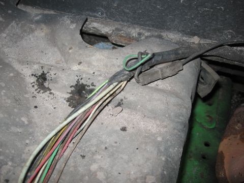 1979 Ford F-150 - A close-up view of a damaged wiring harness, showing multiple frayed wires and a green loop of wire.