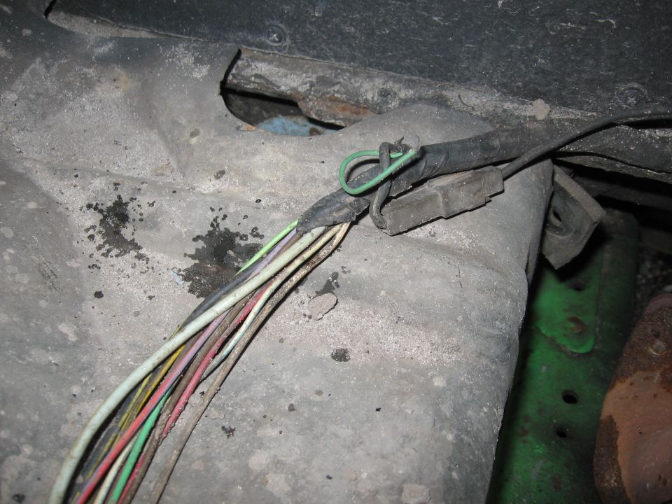 Wiring harness with frayed wires and a green loop