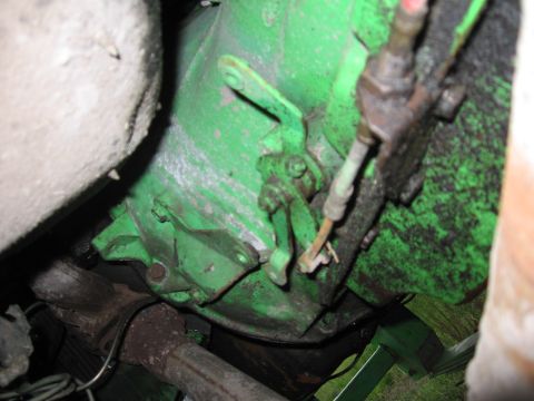 1979 Ford F-150 - Underside view of a vehicle's transmission housing, painted green, with various mechanical components.