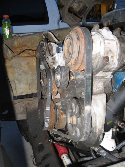 1979 Ford F-150 - Side view of the accessory drive on the front of an engine in a truck, showing an ATLAS 6K0470 serpentine belt routed over the crank, power…