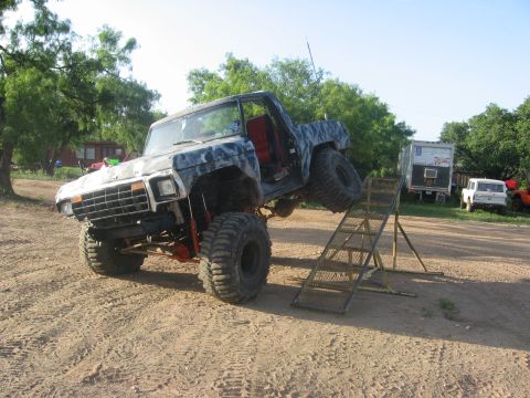 1979 Ford Bronco - This heavily modified off-road vehicle, possibly a 1978 model, is positioned on a ramp with its front wheels elevated.