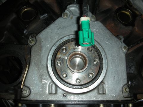 1992 Ford Crown Victoria - Close-up view of an engine transmission bell housing, showing the mating surface and an electrical connector.