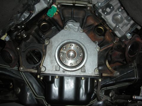 1992 Ford Crown Victoria - Underside view of a vehicle's engine and transmission connection point.