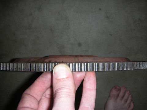 1992 Ford Crown Victoria - Flywheel teeth are visible in this close-up shot, held by a hand.