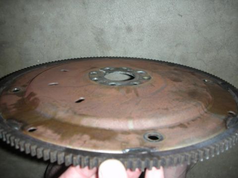 1992 Ford Crown Victoria - A rusty flywheel, a component of a vehicle's transmission, is shown up close.