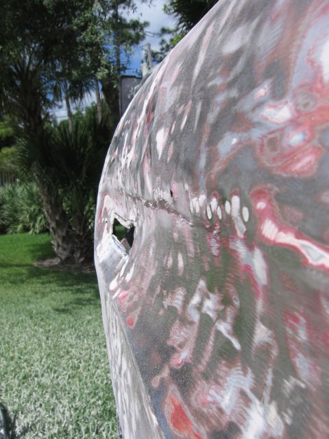 1979 Ford F-150 - Car door with body filler and primer, undergoing repair work.