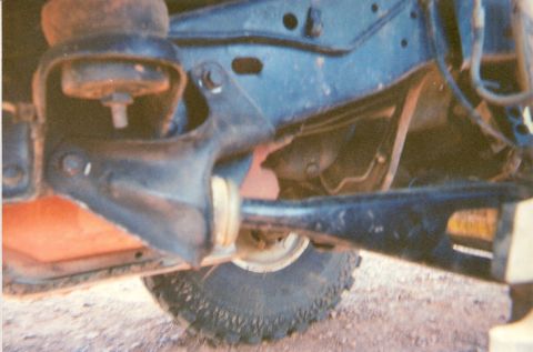 1995 Ford Bronco - Undercarriage view showing suspension parts and a tire. The registry claims this is a 1995 Ford Bronco, but the image does not provide enou…