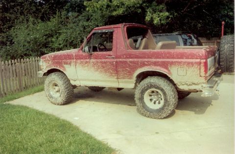 1995 Ford Bronco - This red Ford Bronco appears to be from the early to mid-1990s, not 1995, based on its body style.