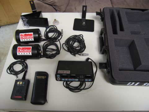 1991 Ford LTD Crown Victoria - Decatur radar equipment including two radar guns, a control unit, and a carrying case.