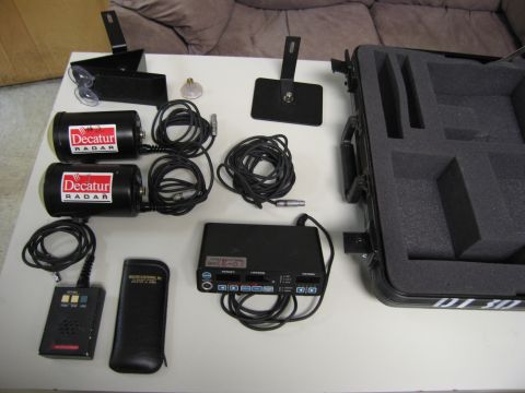 1991 Ford LTD Crown Victoria - A set of Decatur radar equipment, including two radar units and a control unit, is displayed with its accessories and accessories.