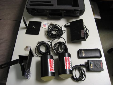 1991 Ford LTD Crown Victoria - Radar speed measurement equipment, including sensors and control unit, is displayed on a table.