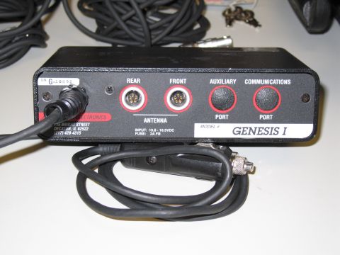 1991 Ford LTD Crown Victoria - Black Genesis I module showing antenna, auxiliary and communications ports with a coiled cable and key set.