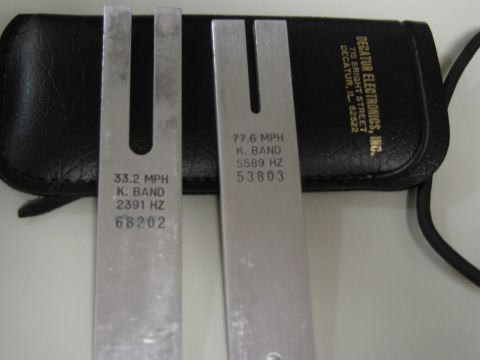 1991 Ford LTD Crown Victoria - Tuning forks used for calibrating radar speed guns, with markings for K. Band frequencies and speeds.