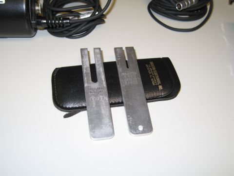 1991 Ford LTD Crown Victoria - Two tuning forks and an electronic device are shown on a white surface.