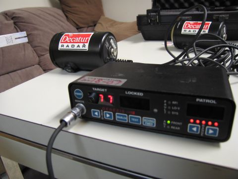 1991 Ford LTD Crown Victoria - A Decatur radar unit and a Genesis IV control box are on a table, with a case in the background.
