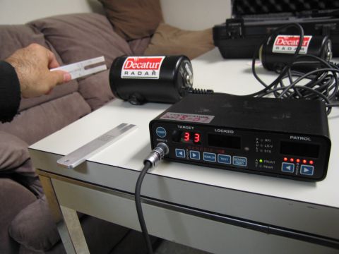 1991 Ford LTD Crown Victoria - Decatur radar equipment and calibration tools are laid out on a table.