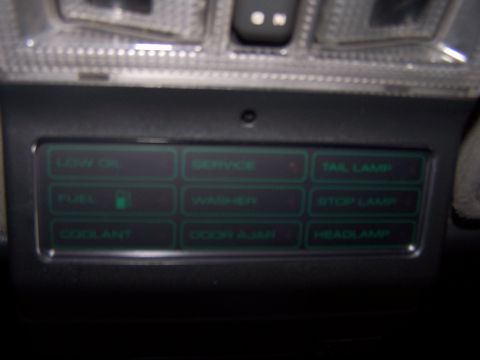 1994 Ford Probe - A close-up view of a vehicle's interior dashboard displays various illuminated warning lights.