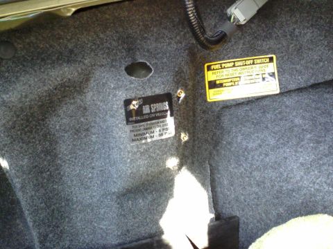 1996 Mercury Grand Marquis - I riveted a small bracket to the fuel inertia switch bracket to mount the two schrader valves Here it is with the carpet on
