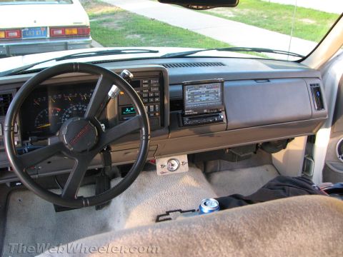 1994 Chevrolet Silverado 3500 - Interior of a Chevrolet pickup showing the gray dash and Chevrolet-badged steering wheel, an aftermarket touchscreen head unit mounted in t…