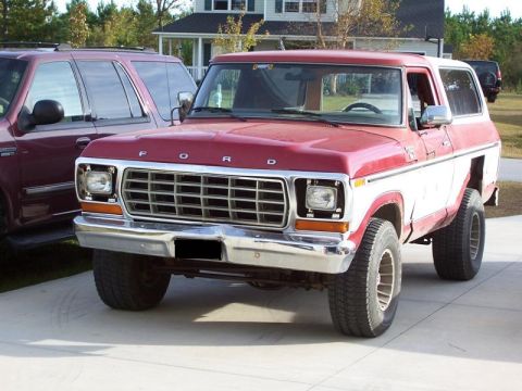 1978 Ford Bronco - Front view of a red and white 1978 Ford Bronco parked on a paved surface.