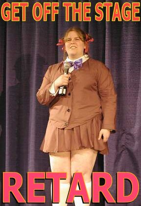 1992 Ford Mustang - A person dressed in a costume stands on a stage with text displayed above and below them.