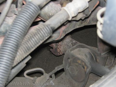 1994 Chevrolet Silverado 3500 - Close-up view of engine exhaust manifold and suspension components.