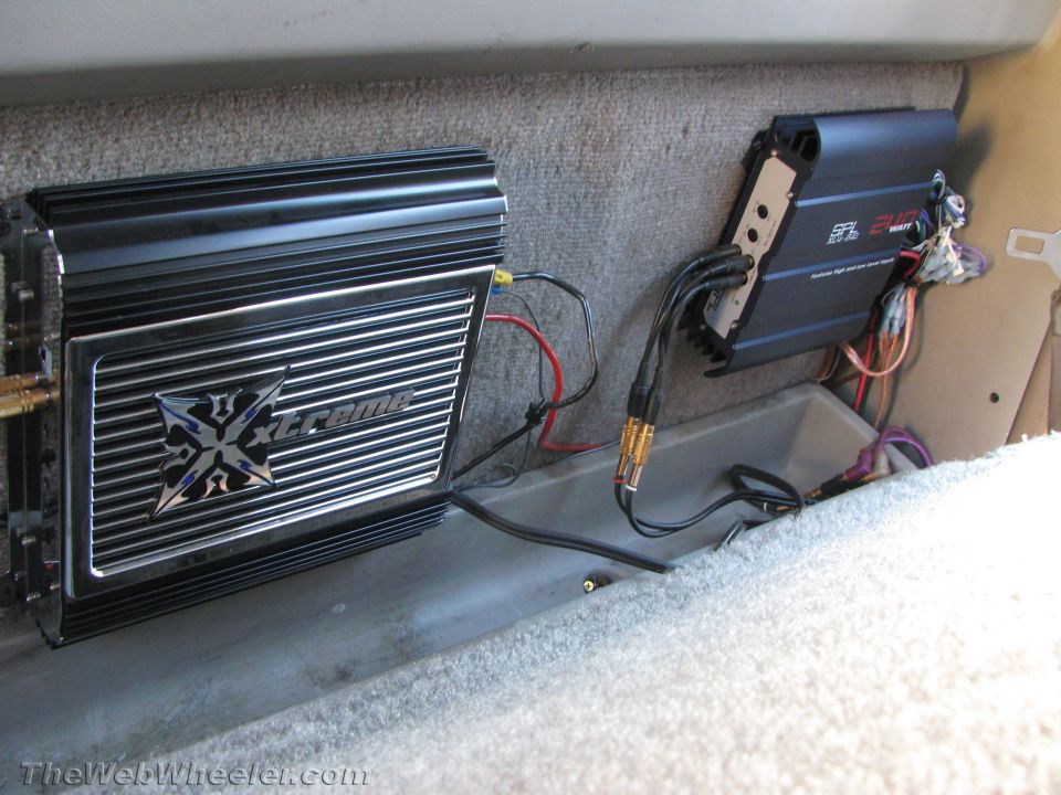 Two car audio amplifiers mounted in a vehicle's interior