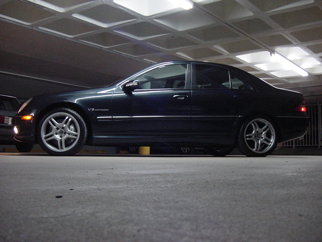 Dark sedan side view, V8 Kompressor badge visible