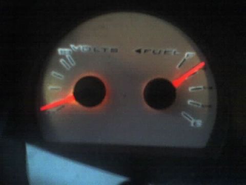2001 Ford Crown Victoria - Close-up of car dashboard gauges showing voltage and fuel levels.