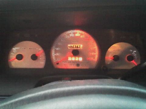 2001 Ford Crown Victoria - The illuminated dashboard gauges show a speedometer and fuel gauge, with 'POLICE INTERCEPTOR' text visible.