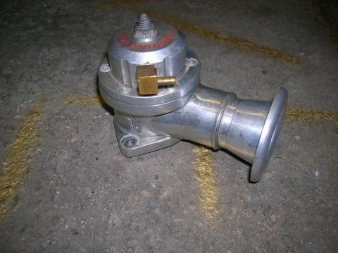 1992 Nissan 240SX - HKS SSQV blow-off valve shown on a concrete surface with yellow markings.