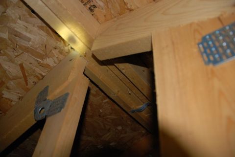 1996 Ford Bronco - Close-up view of the interior framing and construction of an attic space.