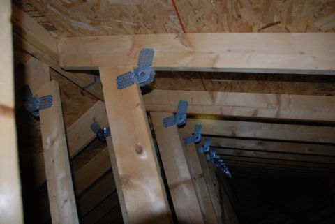 1996 Ford Bronco - Attic framing shows wooden beams reinforced with metal connectors.