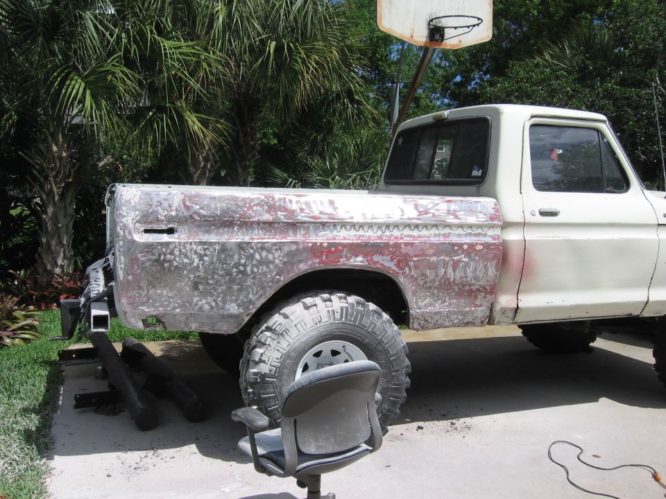 Side view of 1979 Ford F-150 with bed stripped for body work