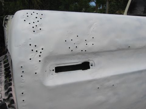 1979 Ford F-150 - This vehicle body panel has been primed and is covered in numerous small holes, possibly for rivets or fasteners.