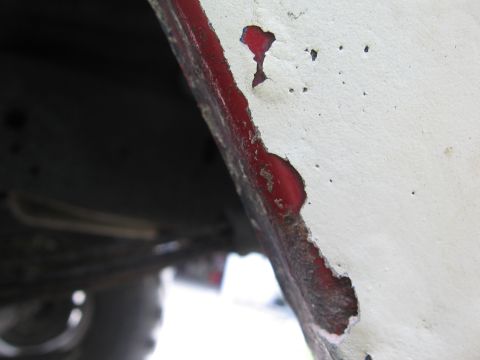 1979 Ford F-150 - Detail of rust and paint damage on a vehicle's body panel, possibly a wheel well.