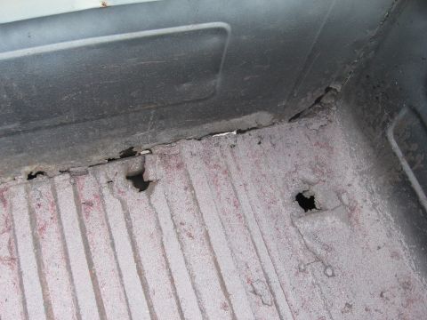 1979 Ford F-150 - The truck bed floor shows significant rust and holes, indicating poor condition.