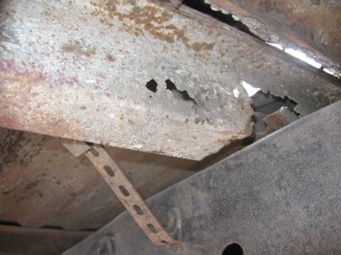 1979 Ford F-150 - Undercarriage view of a heavily rusted frame section, indicating significant body work needed.