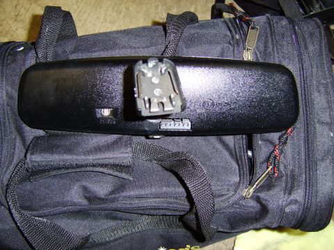 1996 Mercury Grand Marquis - A close-up view of an auto-dimming rearview mirror, showing its electronic components and mounting hardware.
