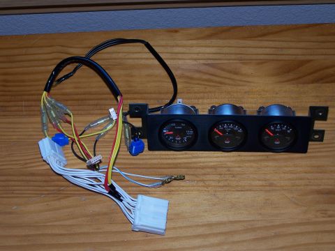 1995 Ford Probe - Aftermarket gauge cluster with three gauges and associated wiring harness.